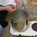 Preparing and boiling materials to get them ready for pulping. 